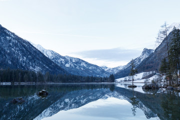 rocks in Lake Hintersee, Ramsau, Bavaria in winter at sunrise and reflexion