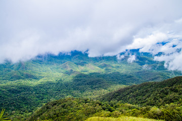 Obraz premium Viewpoint and green fields in the rainy season cover by fog at Doi Luang Tak, Tak Province,Thailand.