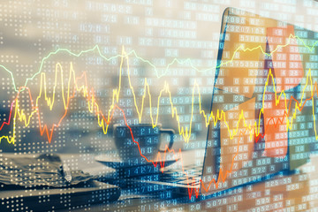 Financial graph colorful drawing and table with computer on background. Double exposure. Concept of international markets.