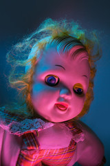 scary old doll under dramatic light