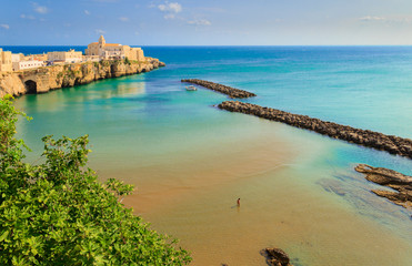 Gargano coast: bay of Vieste, (Apulia) Italy. Panoramic view of the old town. The medieval center perches on a small rocky peninsula: in the background the church of San Francesco.