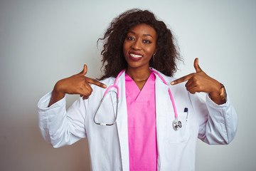African american doctor woman wearing  pink stethoscope over isolated white background looking...