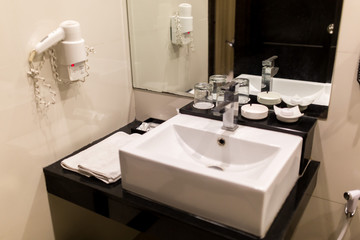Black and white sink with mirror in a luxury granite bathroom interior. Apartment or hotel bathroom