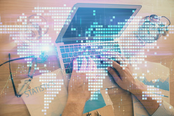 Multi exposure of businessman working on laptop on background. International business hologram in front. Concept of success.