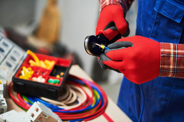 electrician work with cable. crimping pliers in use