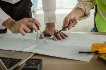 construction worker team drawing and planning about building plan with blueprint, construction...