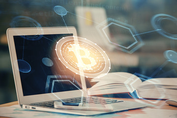 Double exposure of blockchain and crypto economy theme hologram and table with computer background....