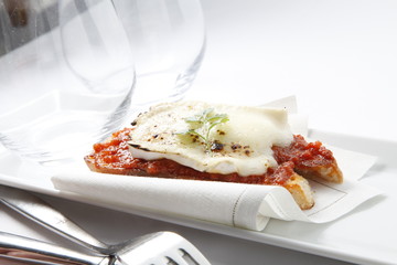 aperitivo , tapa de tomate con bacalao sobre bandeja. appetizer, tomato tapa with cod on a tray.