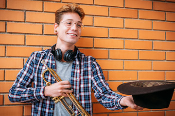 side view shot of a musician holding a trumpet