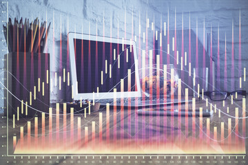 Double exposure of chart and financial info and work space with computer background. Concept of international online trading.