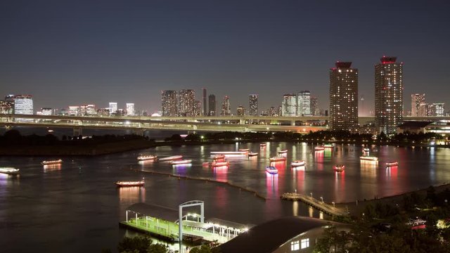 Night time-lapse of dinner cruise boats in Tokyo Bay near Odaiba. Tokyo Japan.