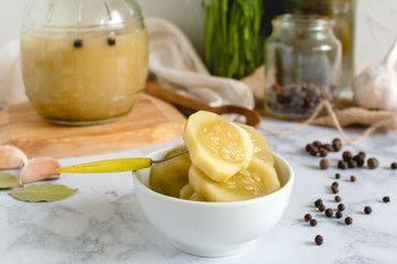 Marinated cucumber in a bowl on the kitchen table
