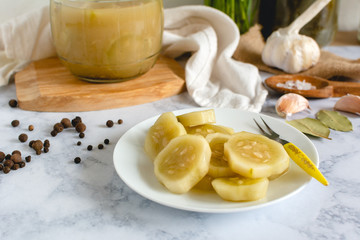 Marinated cucumber on a plate on the kitchen table