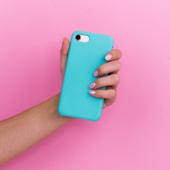 Smartphone in a mint case on a pink background.