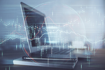 Financial graph colorful drawing and table with computer on background. Multi exposure. Concept of international markets.