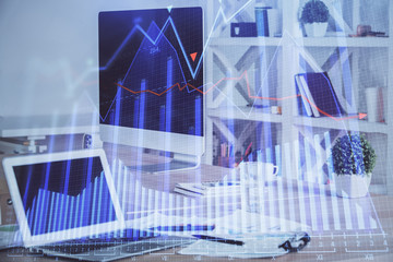 Financial graph colorful drawing and table with computer on background. Multi exposure. Concept of international markets.