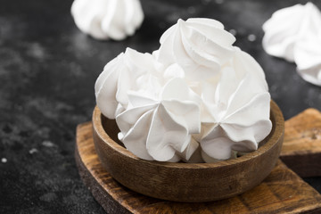 White meringue. French dessert. On the black table
