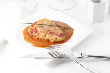 Lomo rebozado con jamón y queso. Breaded loin with ham and cheese.