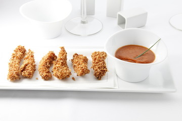 Pollo empanado con salsa barbacoa. Breaded chicken with barbecue sauce.