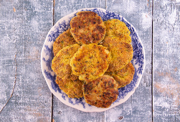 Juicy homemade fried meat and vegetable cutlets with herbs. Turkey, chicken, carrot,  onion, garlic, cubbage, eryngii mushroom, arugula, spinach. Top view