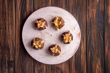 Ripe figs baked with cow's-milk cheese brie and camambert and sprinkled with bread crumbs decorated with mint leaves  on wooden background. Healthy eating concept. top view. copy space