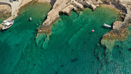Aerial drone photo of paradise rocky seascape forming caves with turquoise clear sea near popular beaches of Pori and Italida, Koufonisi island, Cyclades, Greece