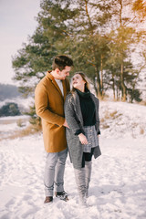 Fototapeta premium happy young couple walking through the park on a snowy day