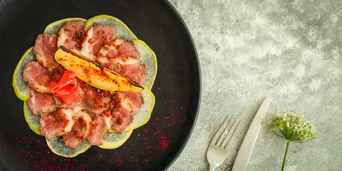 carpaccio meat duck and pear (savory snack, gourmet cuisine) menu concept. food background. copy space. Top view