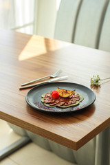 carpaccio meat duck and pear (savory snack, gourmet cuisine) menu concept. food background. copy space. Top view