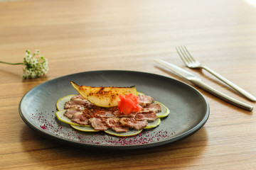 carpaccio meat duck and pear (savory snack, gourmet cuisine) menu concept. food background. copy space. Top view