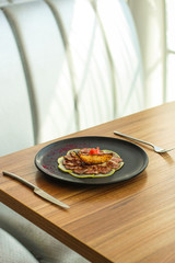 carpaccio meat duck and pear (savory snack, gourmet cuisine) menu concept. food background. copy space. Top view