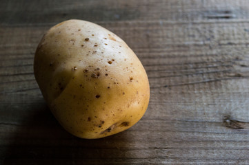 Fototapeta na wymiar potato closeup on wooden background