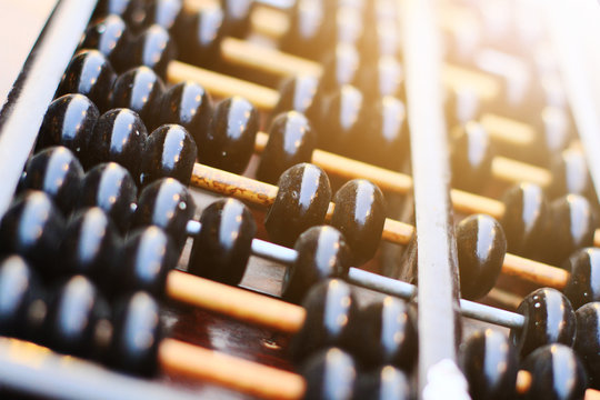 Vintage Chinese wooden abacus in natural sunlight used for calculating in Antique store