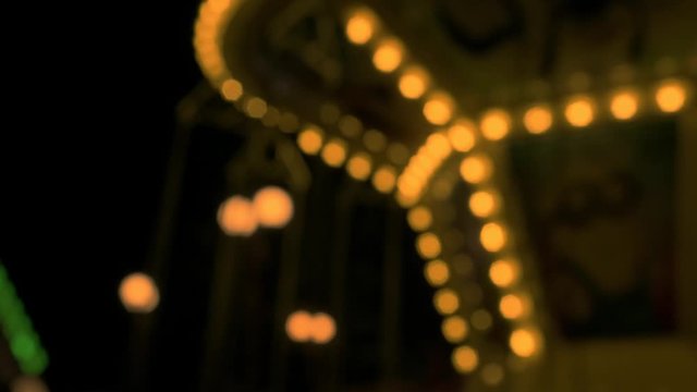 Night view of the carousel in an amusement park. Happy childhood. Rest, joy for children