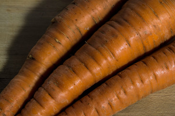 carrots on old wooden background, closeup of vegetables