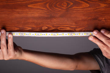 lighting install,the master makes the installation of LED strip on the upper niches of the cabinet at home 