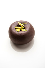 Chocolate Milk peda or pera or pedha made using sweet condensed Milk and cocoa powder, garnished with Pistachio. selective focus