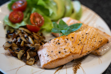Top view of Grilled salmon fillet, mushrooms, cherry tomatoes