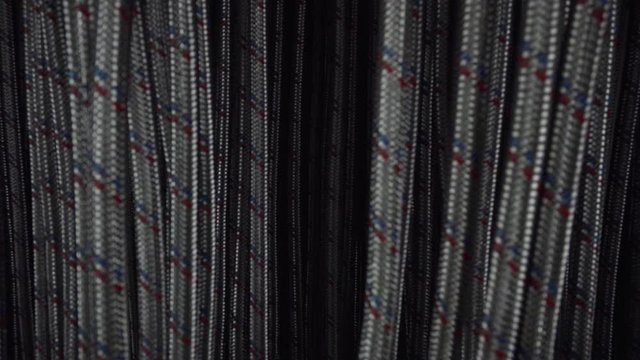 the camera slowly exits a multitude of metal water hoses