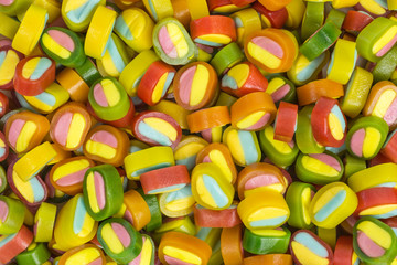 background of gummy candy slices in yellow, pink, green, red, orange and blue