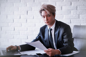 Young Asian businessman in white shirt and tie