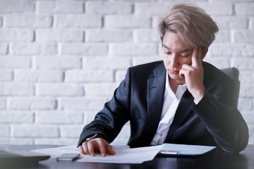 Young Asian businessman in white shirt and tie