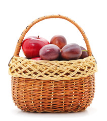Blue plums and apples in the basket.
