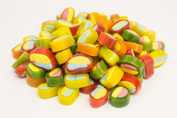 heap of gummy candy slices in yellow, pink, green, red, orange and blue