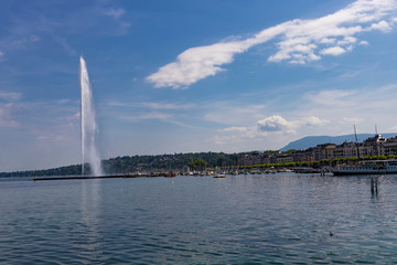 Naklejka na ściany i meble ..Beautiful views of the water jet fountain in Lake Geneva and the cityscape of Geneva Switzerland.