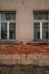 Fototapeta na wymiar Old dilapidated building with missing plaster