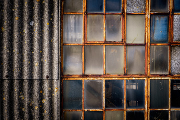 Textures on old industrial window and corogated asbestos