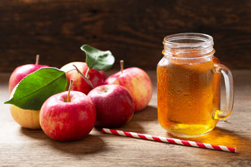 glass jar of apple juice with fresh fruits