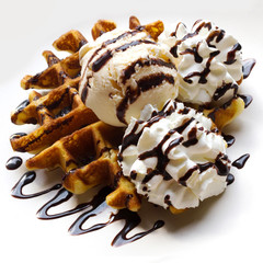 Closeup waffle with vanila ice cream and whipped cream.