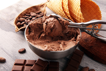 Chocolate coffee ice cream in a bowl on rustic white table